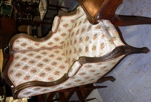 A Louis XV style wing back armchair.
