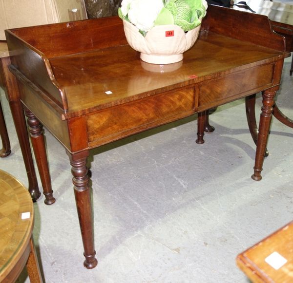 A 19th century mahogany side table, with three quarter galleried back and a pair of drawers, on turned supports, 103cm wide.