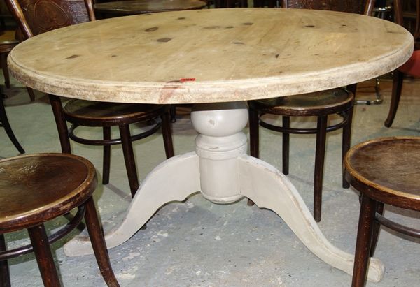 A cream painted pine topped circular dining table, 120cm wide.