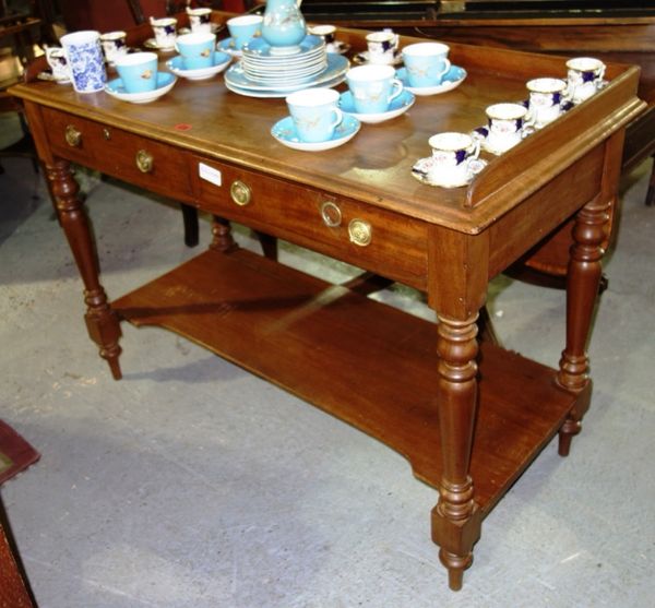 A 19th century mahogany two tier side table, with three quarter galleried back and pair of drawers, 115cm wide.