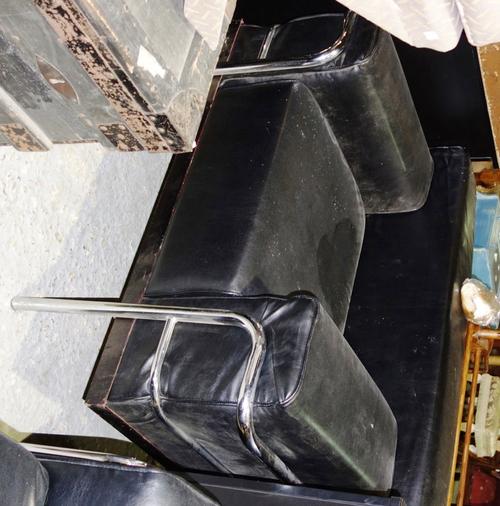 A pair of 20th century chrome and black leather armchairs, 101cm wide. (2)