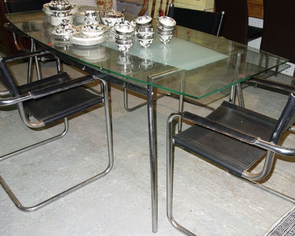 A 20th century chrome and glass rounded rectangular dining table, 180cm wide.
