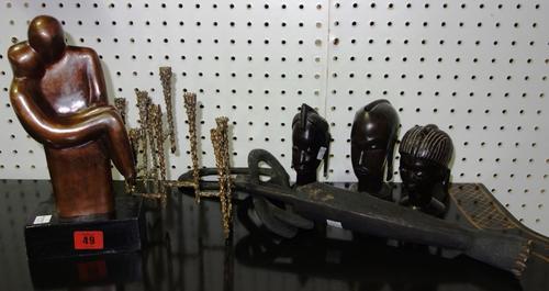 A quantity of collectables, including; three wooden tribal heads, a naturalistic bronze stem vase, a bronzed figure in the style of Henry Moore and su