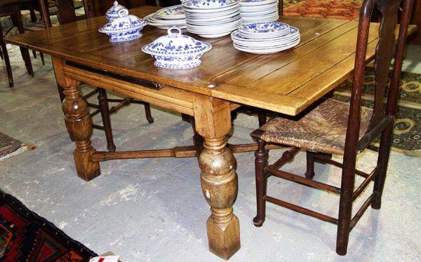 A 20th century oak draw leaf extending dining table, 121cm wide x 181cm fully extended.