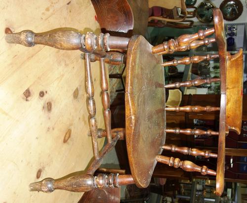 A 19th century elm seated bow back armchair.