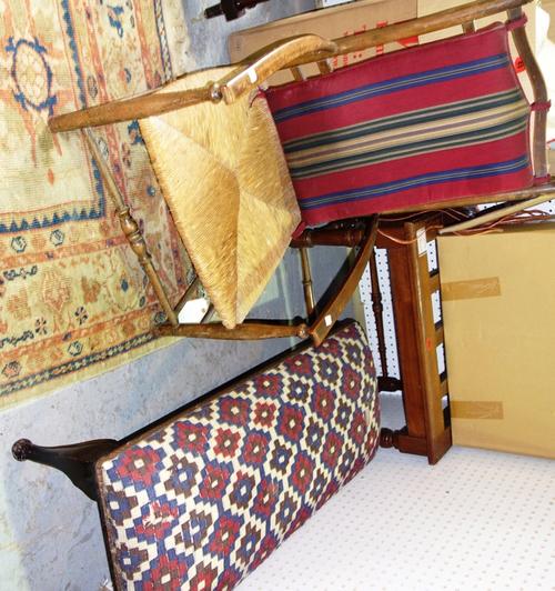 A low walnut and cane armchair, a long mahogany stool and a luggage stand. (3)