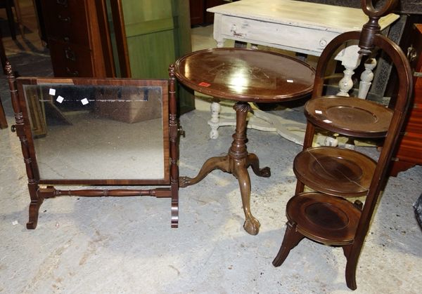 A 20th century mahogany circular occasional table, a three tier cake stand and a swing frame mirror. (3)