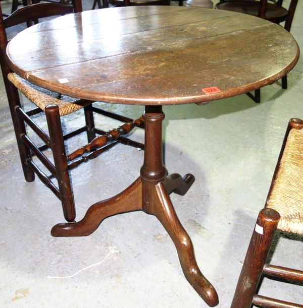 A 19th century circular oak tripod table, 75cm wide