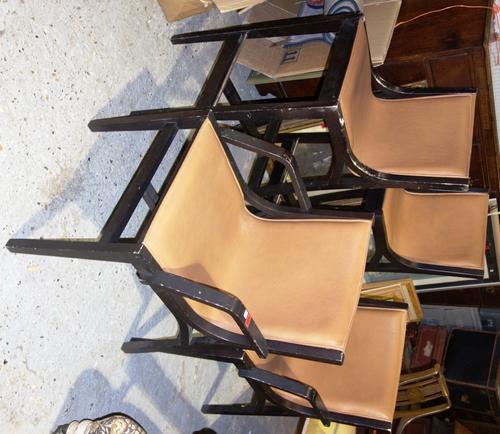 A pair of 20th century brown leather upholstered open armchairs and two high stools to match. (4)