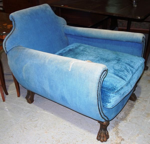 A blue upholstered tub armchair with lion's paw feet.