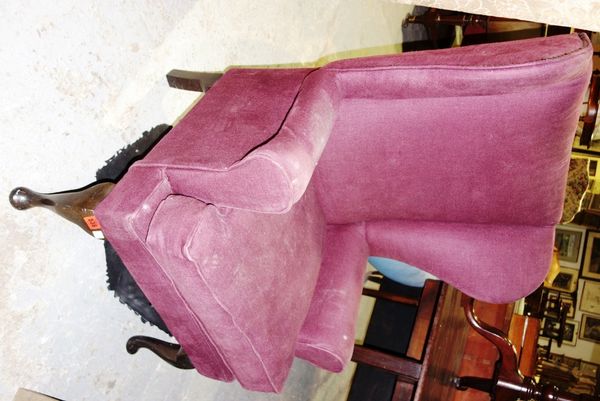 A 20th century purple upholstered wing armchair.
