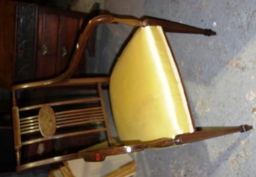 An Edwardian mahogany framed open armchair with inlaid decoration.