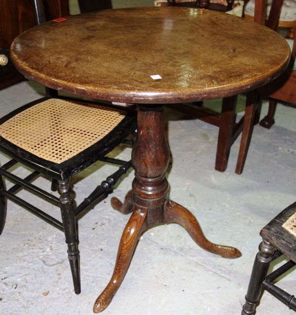 A 19th century oak circular tripod occasional table, 58cm wide.