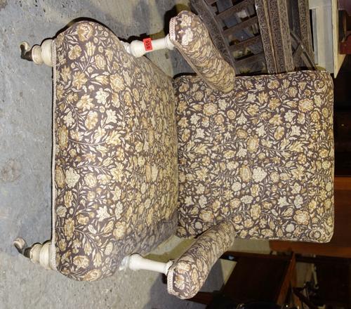 A 19th century white painted floral upholstered easy armchair.