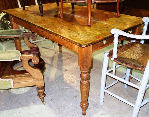 A 19th century rectangular pine kitchen table with single drawer and turned supports, 136cm wide.