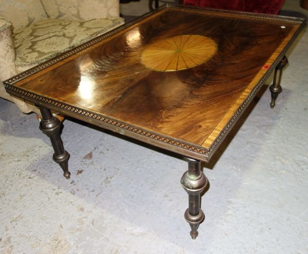 A Regency style mahogany rectangular coffee table with pierced brass gallery, central fan medallion and turned supports, 107cm wide.