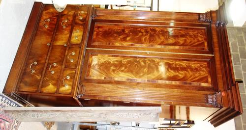 In the manner of 'Hallet & Vile', a 20th century mahogany linen press/wardrobe with stepped breakfront cornice over a pair of flame mahogany panel doo