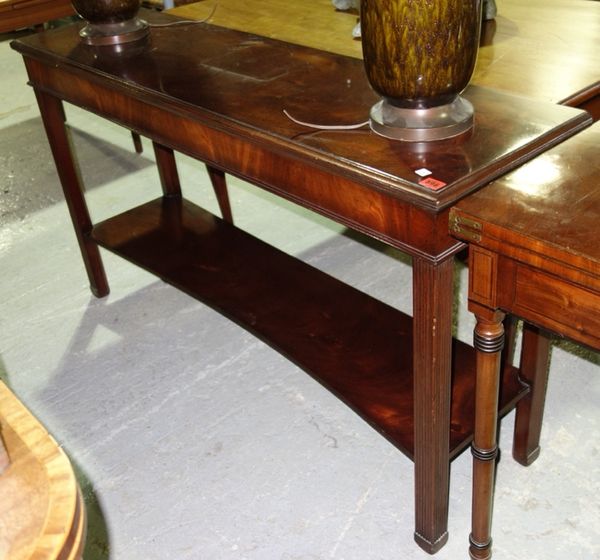 A 20th century mahogany two tier rectangular console table, with reeded supports and concave undertier, 138cm wide.