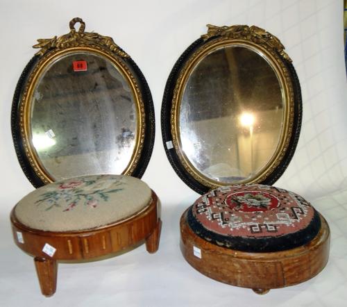 A pair of 19th century oval ebonised and gilt decorated wall mirrors, together with two similar 19th century walnut circular stools. (4)