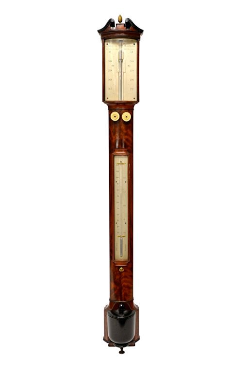 A mid-19th century mahogany stick barometer by 'J. B. Dancer, Manchester', with brass pineapple finial and broken arch pediment over a bow front glaze