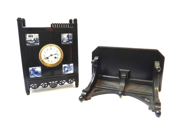An Aesthetic movement ebonised bracket clock, late 19th century, the carved rectangular body inset with four blue and white ceramic tiles, centred wit