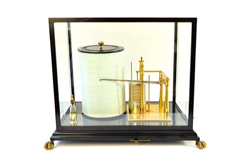 A large barograph by Short and Mason, London, with brass clockwork drum, aneroid recording arm with stop lever and ink bottle in a glazed ebony case o