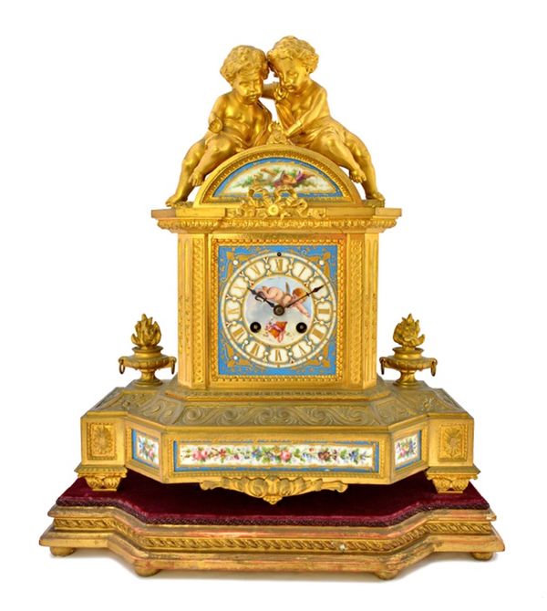 A French ormolu and porcelain mounted mantel clock, late 19th century, with twin cherub surmount over a porcelain dial plate hand painted with a Cupid