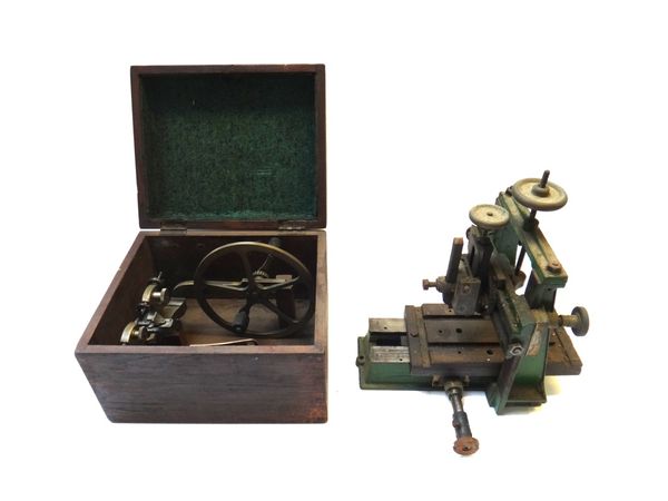 A gilt steel watch maker's lathe, stamped 'Dracip Patent', boxed, and a green painted steel lathe (part). (2)