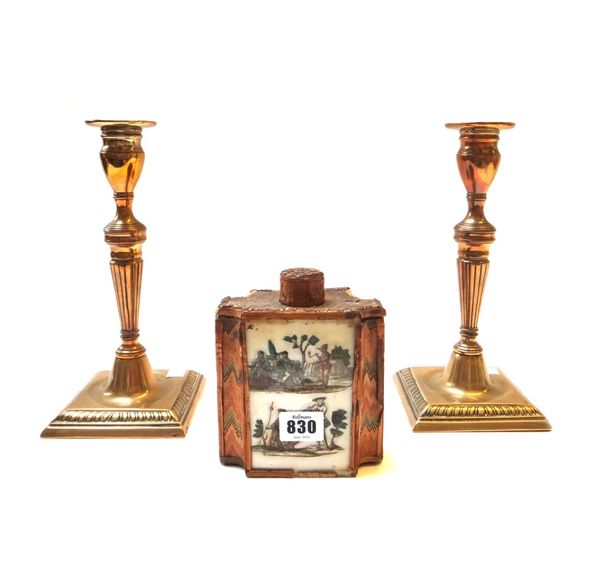 A Louis XVI straw work and declomania glass set tea caddy, late 18th/early 19th century (a.f), 14cm high, and a pair of George III brass ejector candl