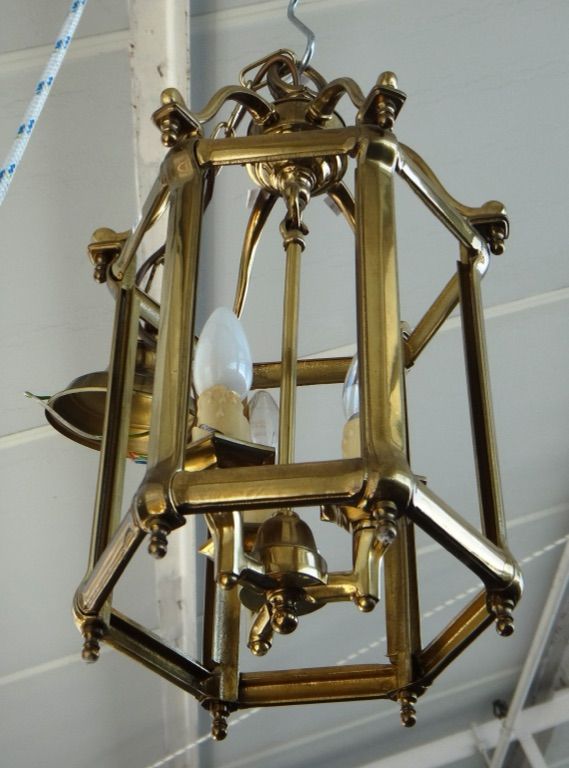 A pair of modern Georgian style gilt brass hall lanterns, of hexagonal form, with shaped overtier, internal three light fitment and bevelled glass pan