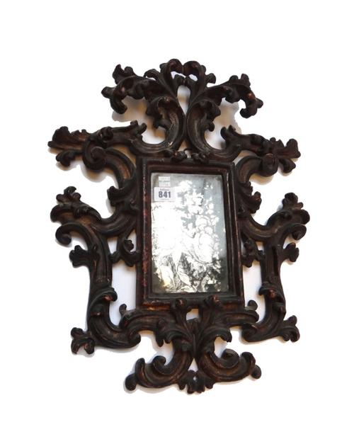 An Italian silvered mirror plate, early 18th century, depicting the Virgin and housed in a gilt and polychrome Florentine carved wooden frame, 51cm hi