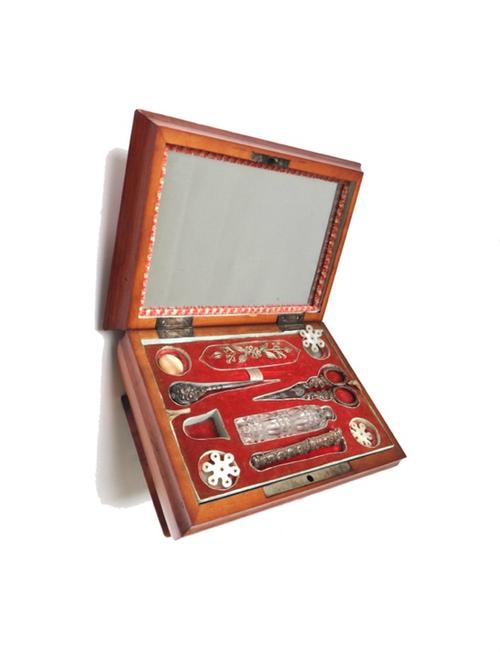 A French fruitwood and and rosewood banded sewing casket, 19th century, the shaped case with foliate cast ring handle and metal embellishments, the in