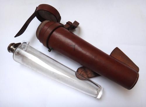 A glass and white metal mounted hunting flask by Swaine and Adeney, early 20th century, of tapering cylindrical form, in a leather case, 27cm, and an