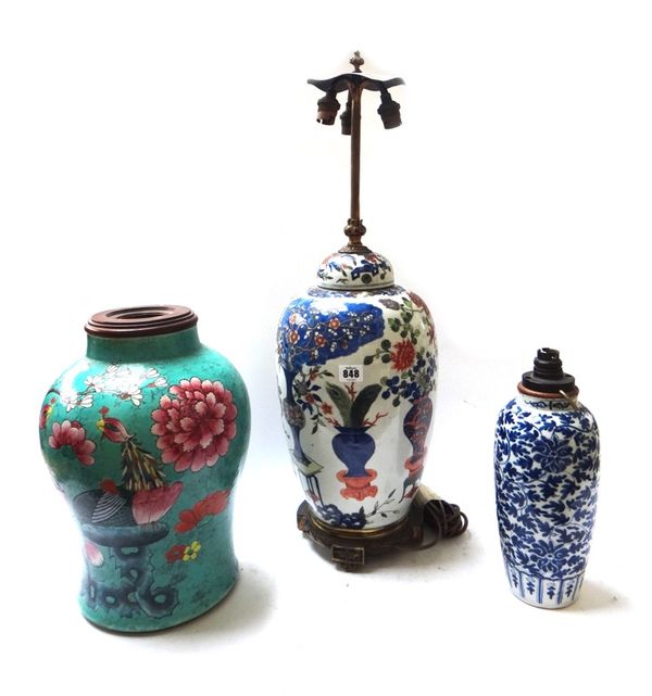 A Chinese famille rose porcelain vase and cover fitted as a table lamp, on a wooden stand, 38cm high, a Chinese blue and white lamp base and a Chinese