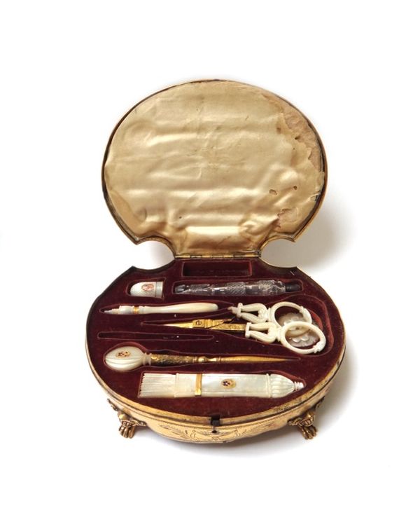A French gilt metal and carved shell sewing box, 19th century, with a velvet lined fitted interior and partial mother of pearl and gilt metal sewing i