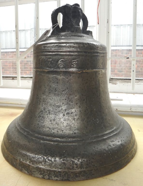 An early George III bronze bell dated 1763, with internal ebonised clapper on chain, 35cm high.