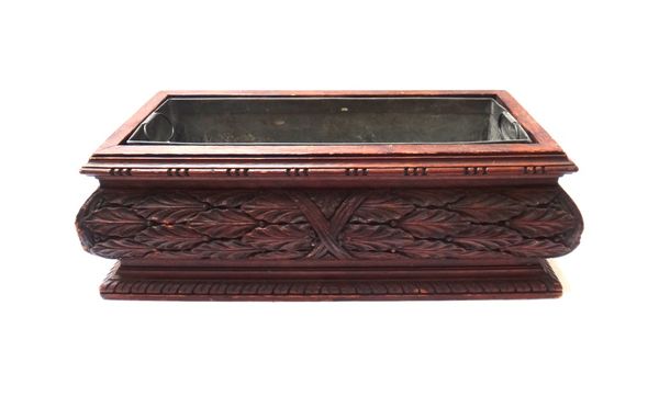 A Black Forest carved wooden jardinière, late 19th century, of rectangular form with all over foliate design and internal metal liner, 50cm wide.