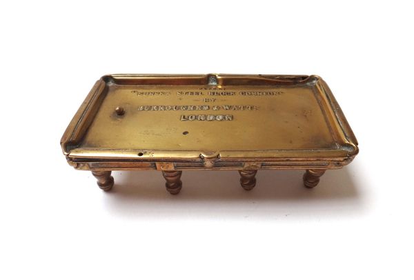 A miniature brass snooker table, late 19th century, detailed 'Patent Eureka steel block cushions by Burroughes & Watts, London', 10.5cm wide.
