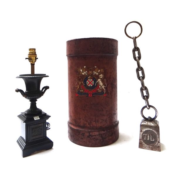 A leather shot bucket decorated with the Royal Standard, 40cm high, a bronze and marble table lamp of two handled urn form, and an iron door stop cast