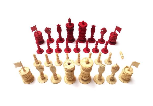 A Cantonese stained ivory chess set, 19th century, of carved foliate form (a.f), 10cm high. (32)