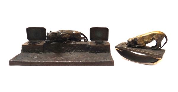 A French bronze desk top inkwell, late 19th century, centrally cast with a prowling tiger flanked by two inkwell reservoirs, unsigned, 37cm wide, toge
