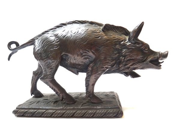 A Continental bronze boar, 19th century, cast on a naturalistic rectangular base, 34cm wide.