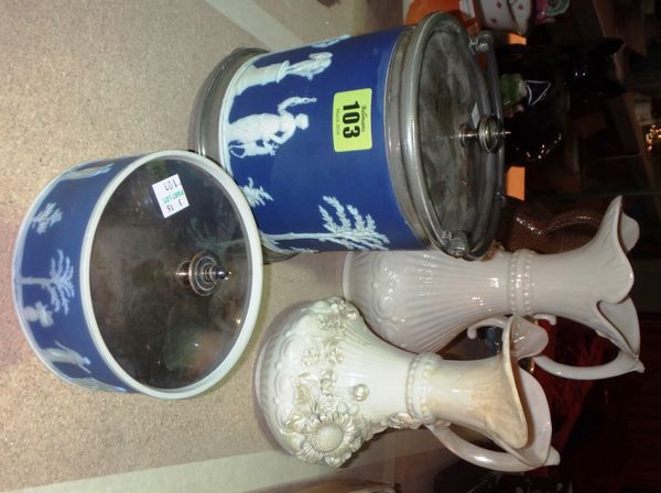 A Belleek porcelain jug moulded with flowers, another smaller, a Jasperware biscuit barrel and a Jasperware lidded pot.