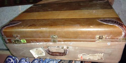 An early 20th century canvas and leather bound suitcase.