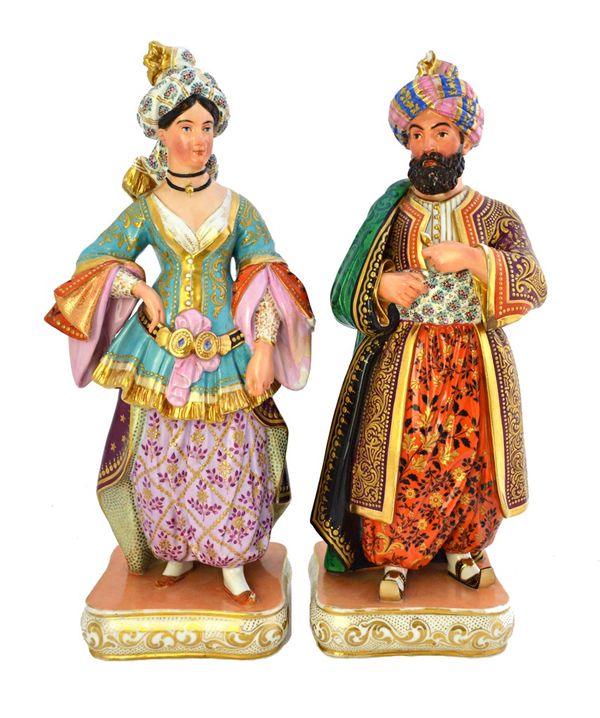 A pair of Paris porcelain figural bottles and stoppers, mid 19th century, probably by Jacob Petit, modelled as a Sultan and Sultana, 34.5cm high. (2)