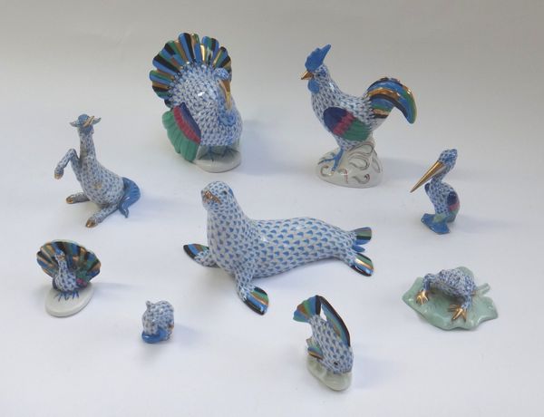 Nine Herend porcelain animals decorated in a gilt blue Imari pattern, comprising; a cockerel (14cm high), a turkey, a seal, a peacock, a frog, a pelic