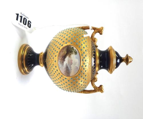 A Coalport porcelain two handled vase and cover, circa 1900, centrally painted with a lakescape and signed 'E.O.B.', within a turquoise jewelled and g