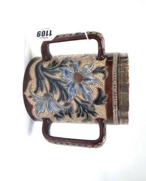 A Doulton Lambeth stoneware tyg, late 19th century, incised with flowers against a mottled brown ground with plated rim, presentation engraved 'Presen