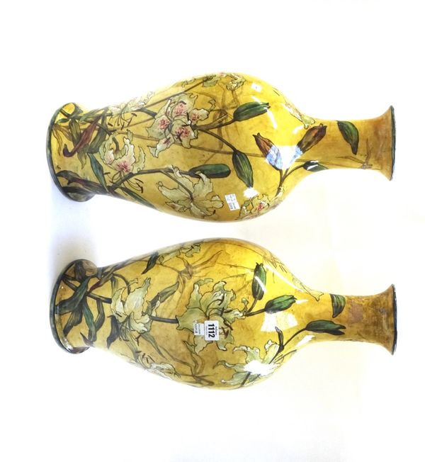 A pair of Doulton Lambeth faience pottery vases of large proportions, late 19th century, each foliate decorated against a yellow ground, with black pa