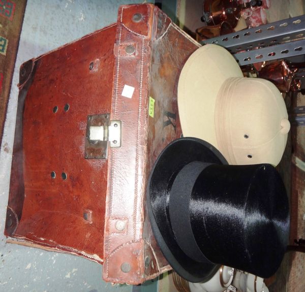 A boxed top hat, a Safari type helmet and a brown leather lift top box.